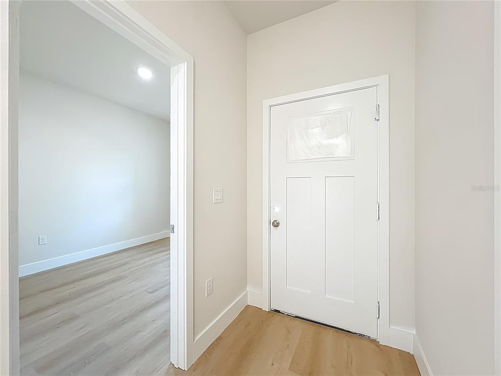 356 West 4th Street Apopka, FL 32703 - Photo 31 of 32 an empty room with wooden floor and closet