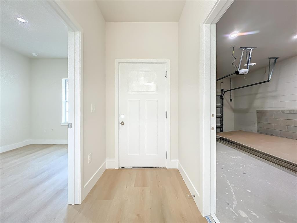 356 West 4th Street Apopka, FL 32703 - Photo 32 of 32 a view of a hallway with wooden floor and a bathroom