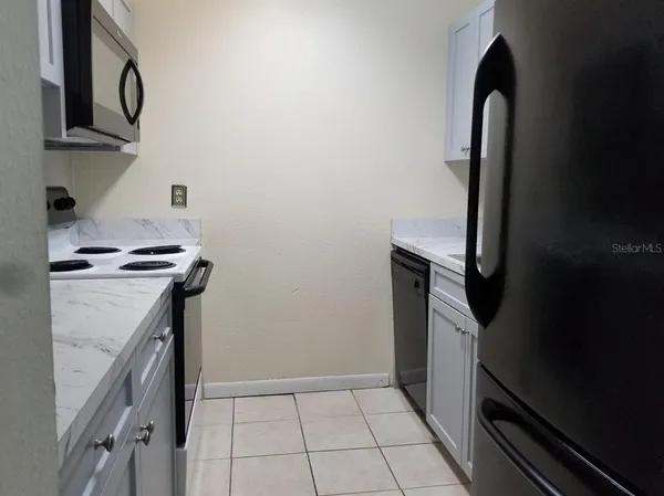 a kitchen with a sink and a stove top oven
