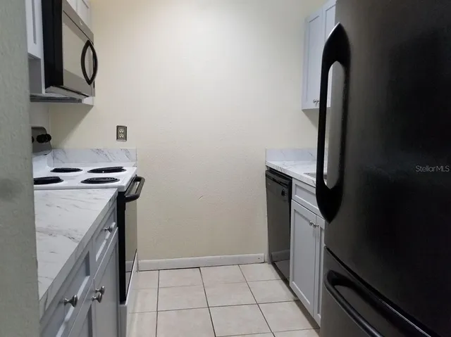 a kitchen with a sink and a stove top oven