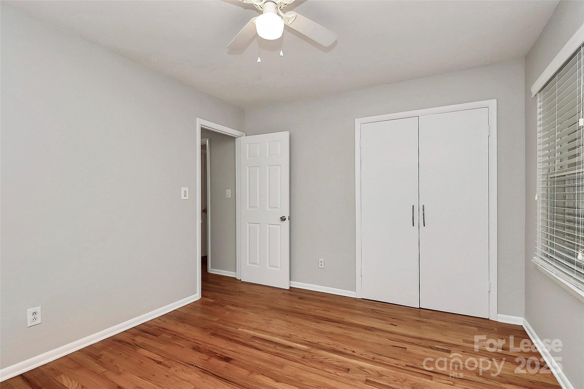8911 Reames Road Charlotte, NC 28216 - Photo 19 of 31 a view of an empty room with wooden floor