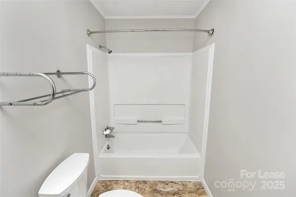 a bathroom with a shower a toilet and a shower