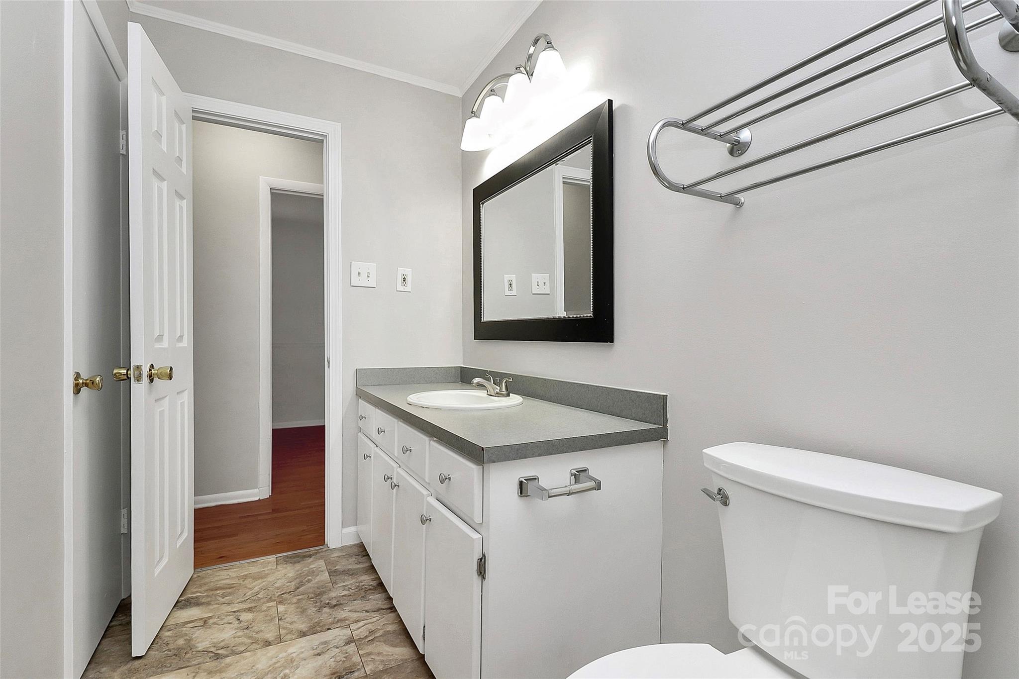 8911 Reames Road Charlotte, NC 28216 - Photo 25 of 31 a bathroom with a granite countertop sink mirror vanity and toilet