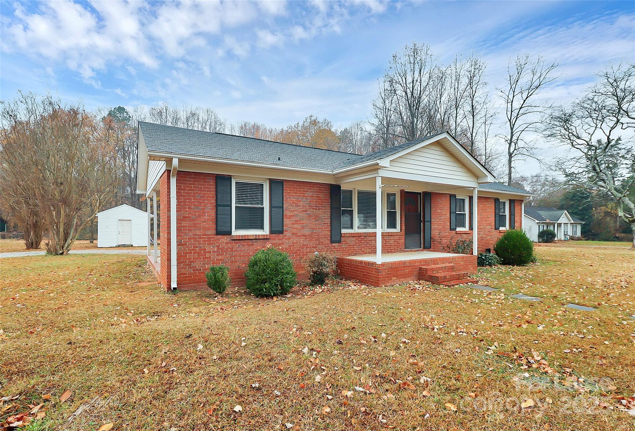8911 Reames Road Charlotte, NC 28216 - Photo 3 of 31 a front view of a house with a yard and garage