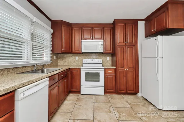 a kitchen with a stove sink and cabinets