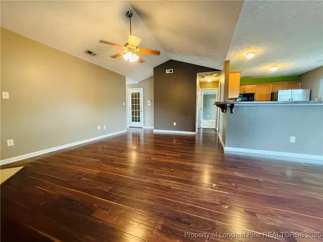 a view of a room with wooden floor