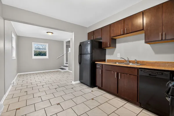 a kitchen with a refrigerator sink and cabinets