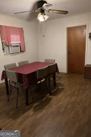 a dining room with a wooden table and chairs