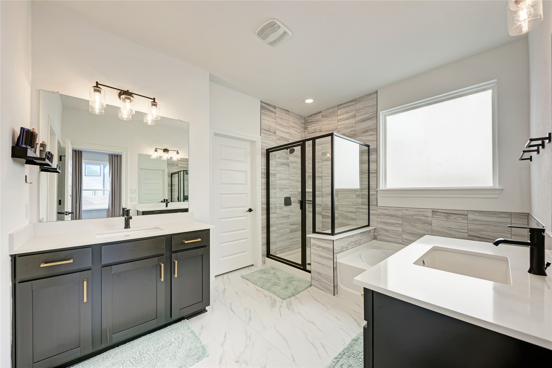 316 Regatta Trail Leander, TX 78641 - Photo 20 of 37 Dual vanity with quartz countertops, matte black fixtures, and gold-finish hardware