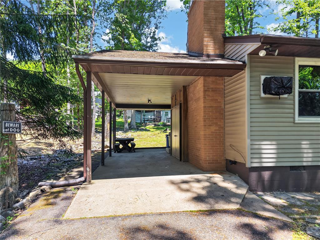 18 White Oak Road Nesquehoning, PA 18240 - Photo 34 of 52 A covered porch offers a sheltered outdoor space alongside the home's brick and siding exterior.