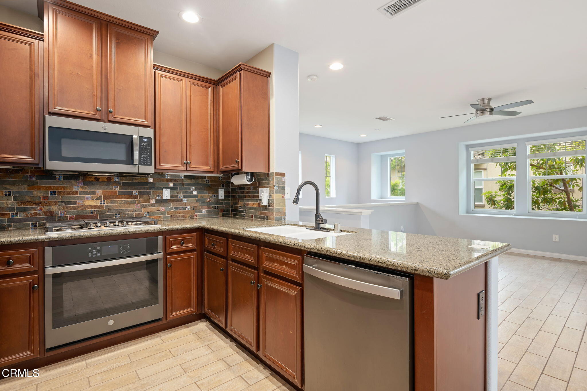 3233 Moss Landing Boulevard Oxnard, CA 93036 - Photo 11 of 25 a kitchen with stainless steel appliances granite countertop a sink stove and microwave