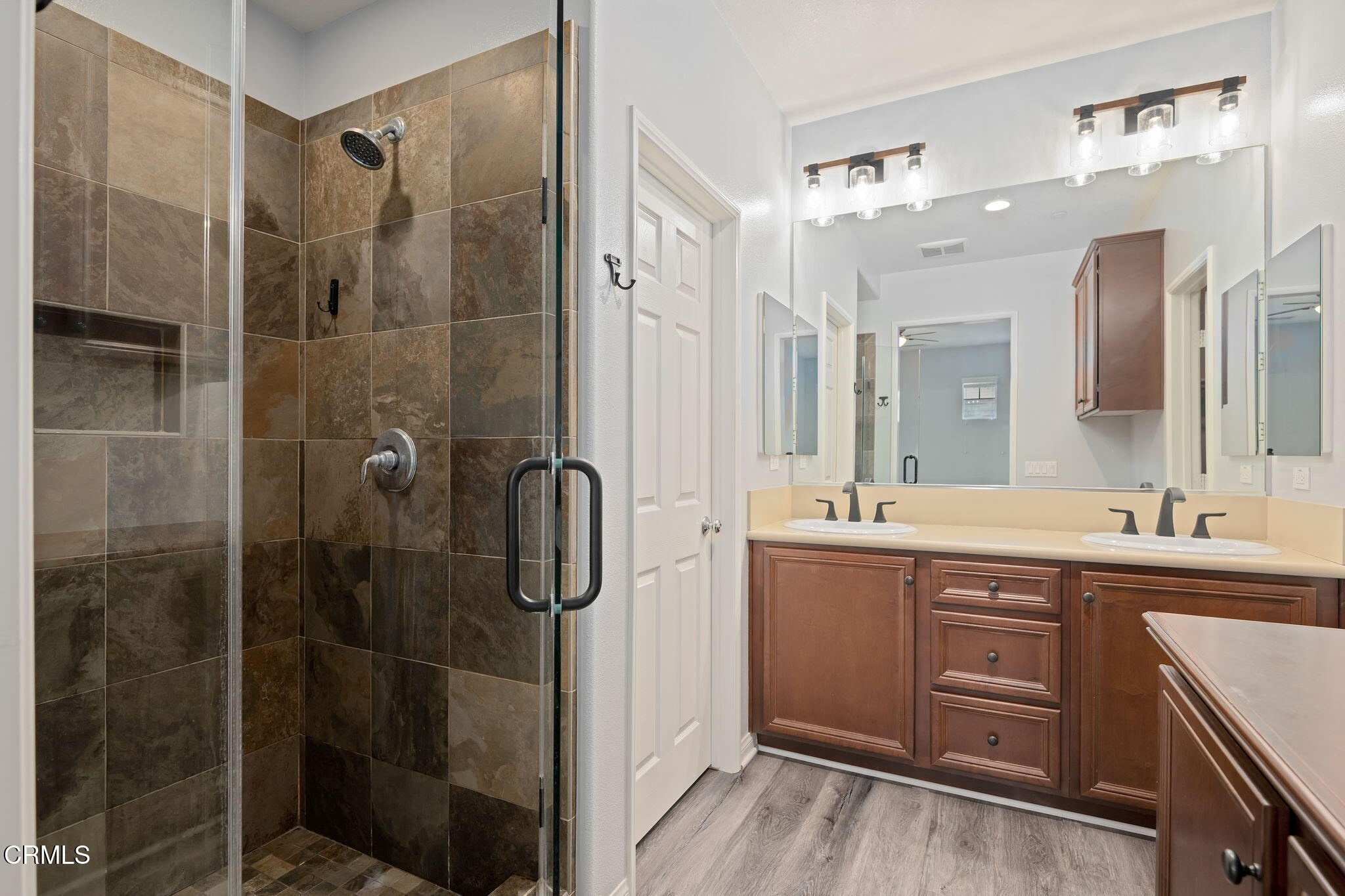 3233 Moss Landing Boulevard Oxnard, CA 93036 - Photo 12 of 25 a bathroom with a double vanity sink a mirror and a shower