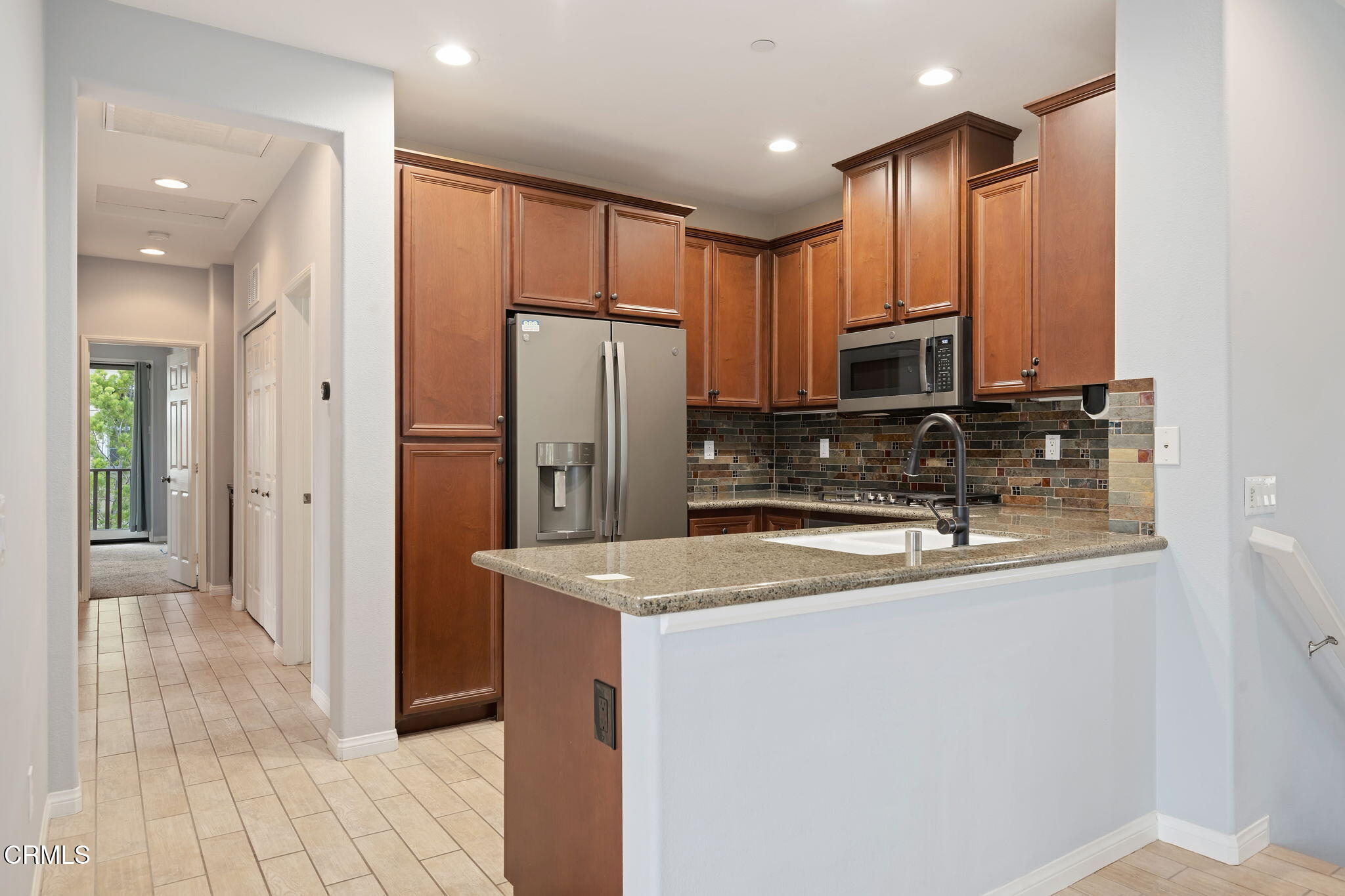 3233 Moss Landing Boulevard Oxnard, CA 93036 - Photo 10 of 25 a kitchen with stainless steel appliances granite countertop a refrigerator a sink and a stove