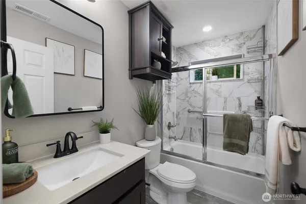 a bathroom with a sink toilet and shower