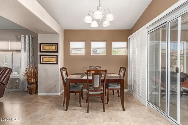 a view of a dining room with furniture and chandelier