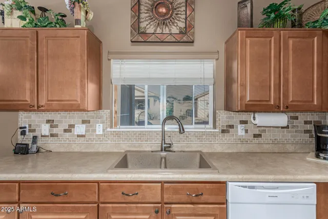 a kitchen with stainless steel appliances granite countertop a sink a stove and cabinets