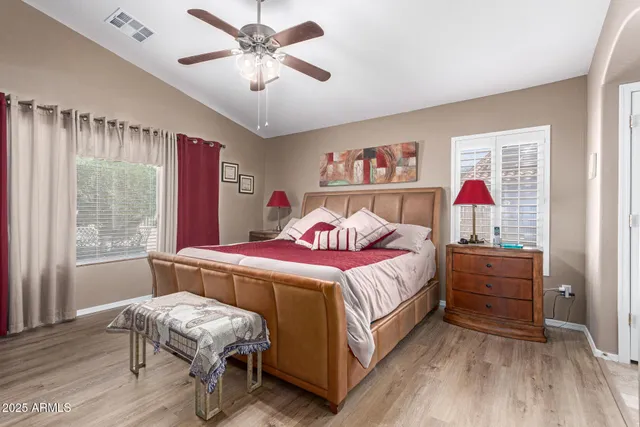 a bedroom with a bed and a chandelier