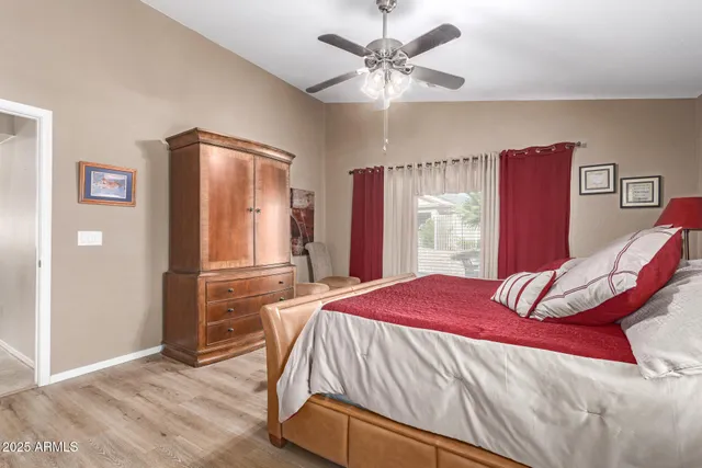a bedroom with a large bed and a chandelier
