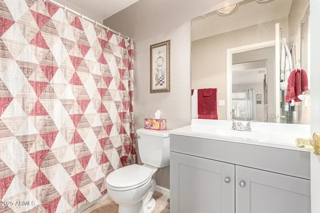 a bathroom with a sink toilet vanity and shower