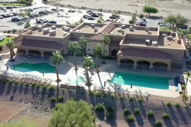 an aerial view of a house with a yard basket ball court and outdoor seating