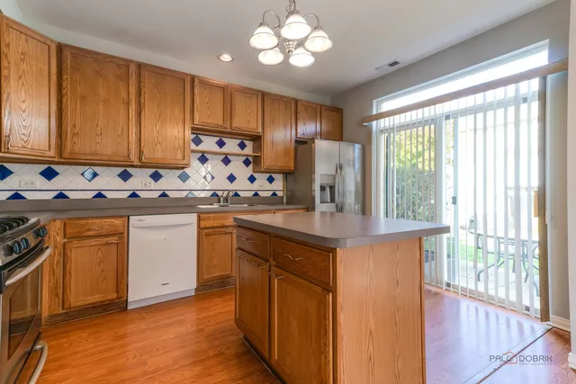 a kitchen with a stove cabinets and wooden floor