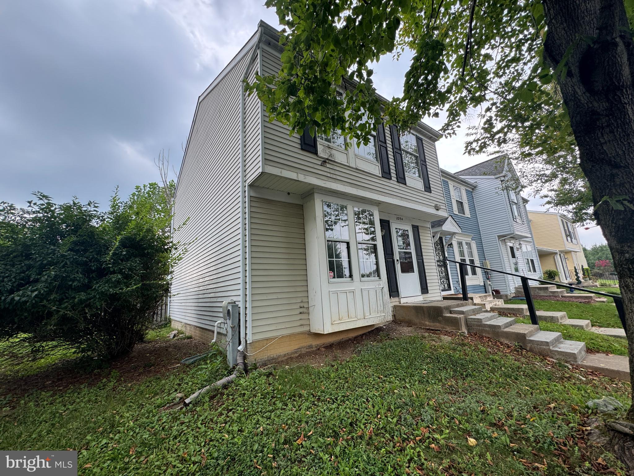2254 Riding Crop Way Windsor Mill, MD 21244 - Photo 3 of 10 a view of a white house with a yard and plants
