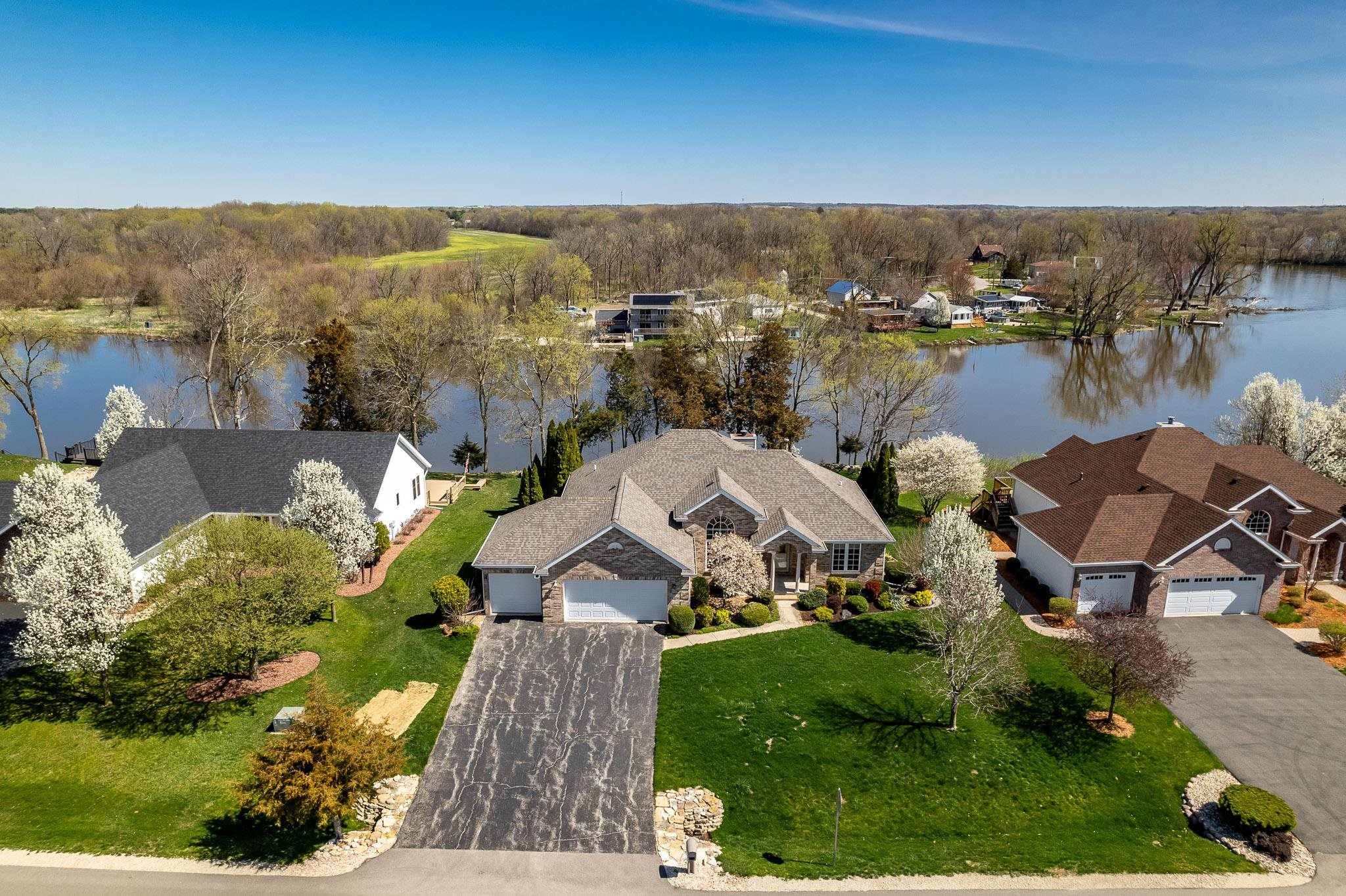 10703 Chicory Ridge Way Roscoe, IL 61073 - Photo 4 of 64 an aerial view of a house with a garden and lake view