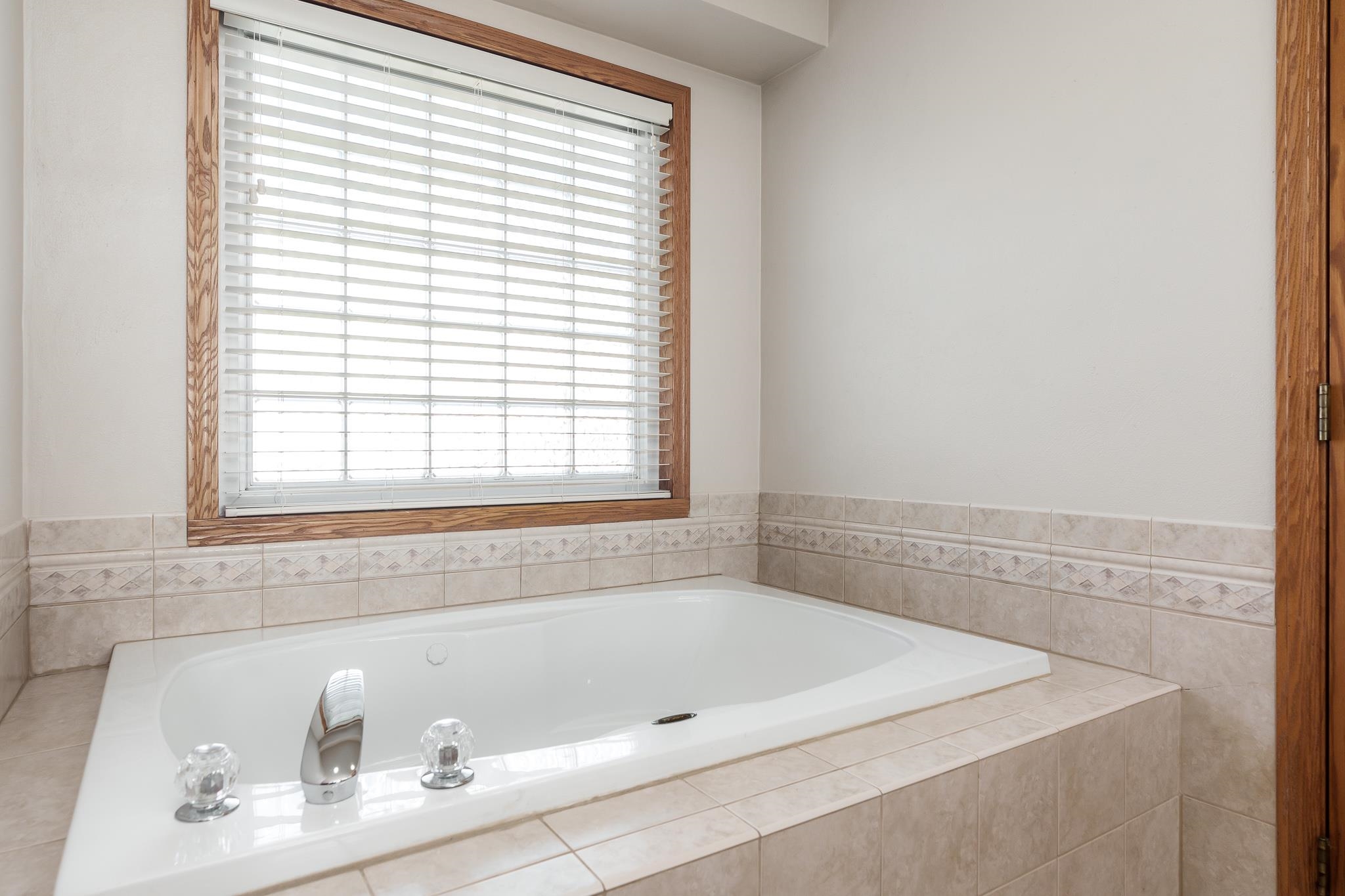 10703 Chicory Ridge Way Roscoe, IL 61073 - Photo 50 of 64 a bath tub sitting in a bathroom next to a window