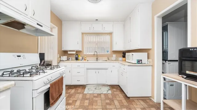 a kitchen with stainless steel appliances a refrigerator stove and sink