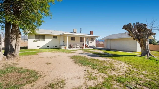 a view of house with swimming pool yard and outdoor seating