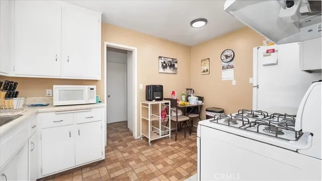 a kitchen with a stove a sink and a refrigerator