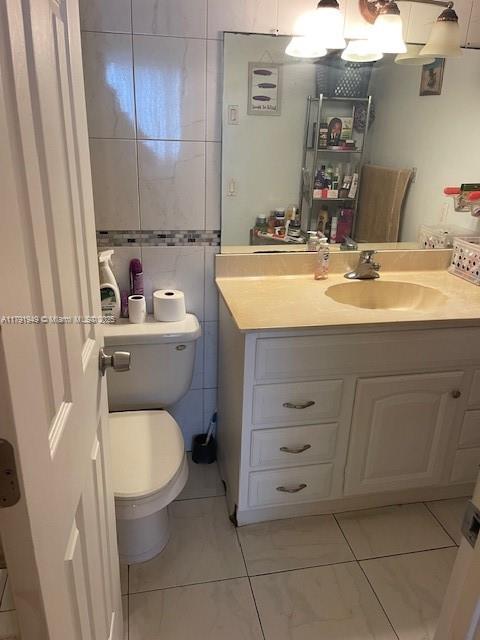 4400 Hillcrest Drive, Unit 701B Hollywood, FL 33021 - Photo 16 of 20 a bathroom with a granite countertop toilet sink and mirror