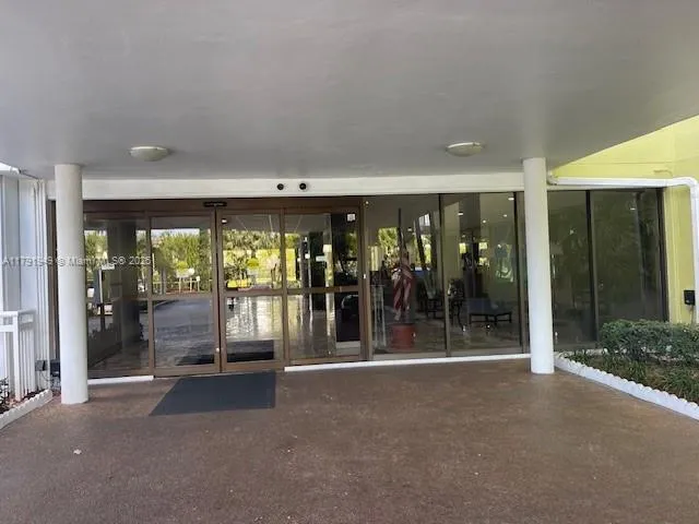 a view of a building with floor to ceiling window and outdoor