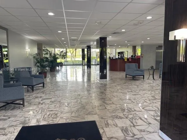 a lobby with furniture and a rug
