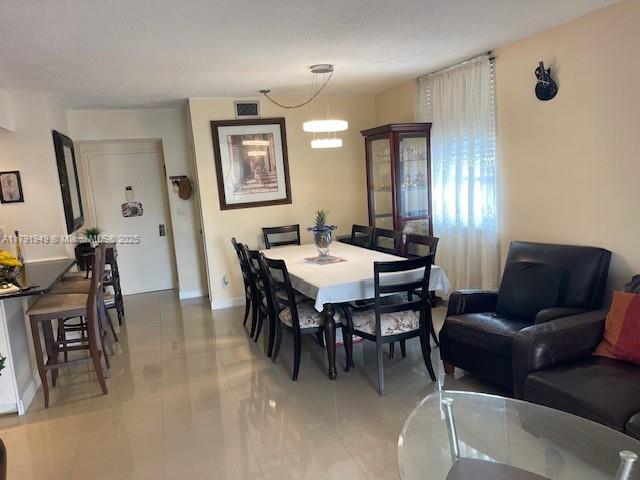 4400 Hillcrest Drive, Unit 701B Hollywood, FL 33021 - Photo 7 of 20 a view of a a dining room with furniture and a chandelier