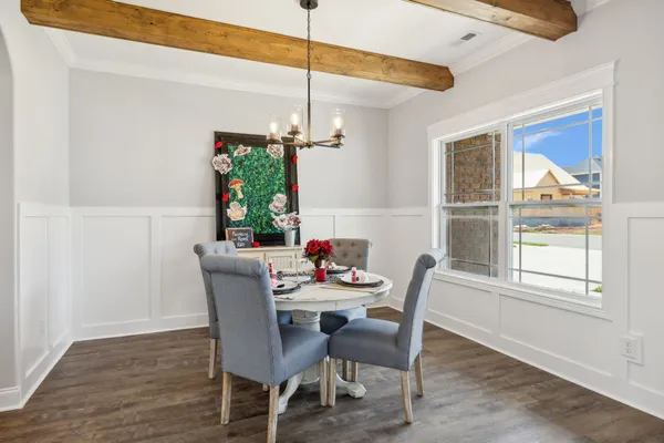 a living room with furniture fireplace and dining table