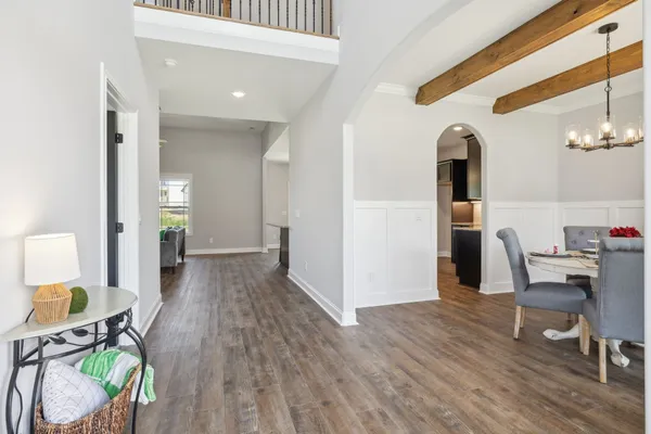 a view of empty room with wooden floor and window