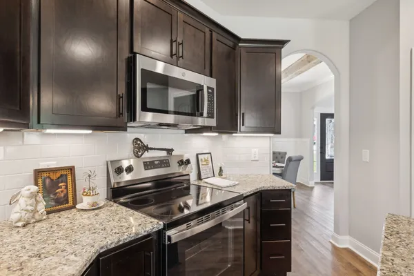 a bathroom with a granite countertop double vanity sink and a mirror