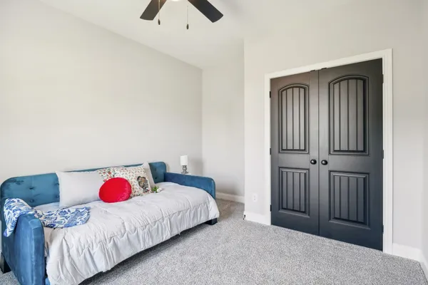 an empty room with a window and a fan