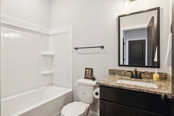 an empty room with closet and a chandelier fan