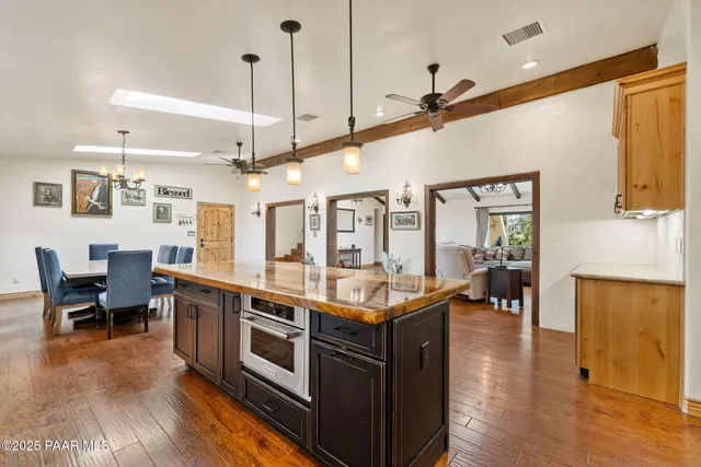 a kitchen with stainless steel appliances granite countertop a stove and wooden floors