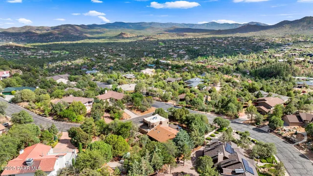 an aerial view of a house with a yard and garden