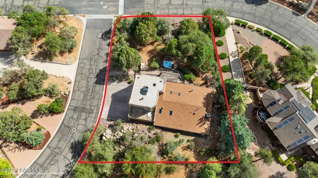 an aerial view of a house with a yard and garden