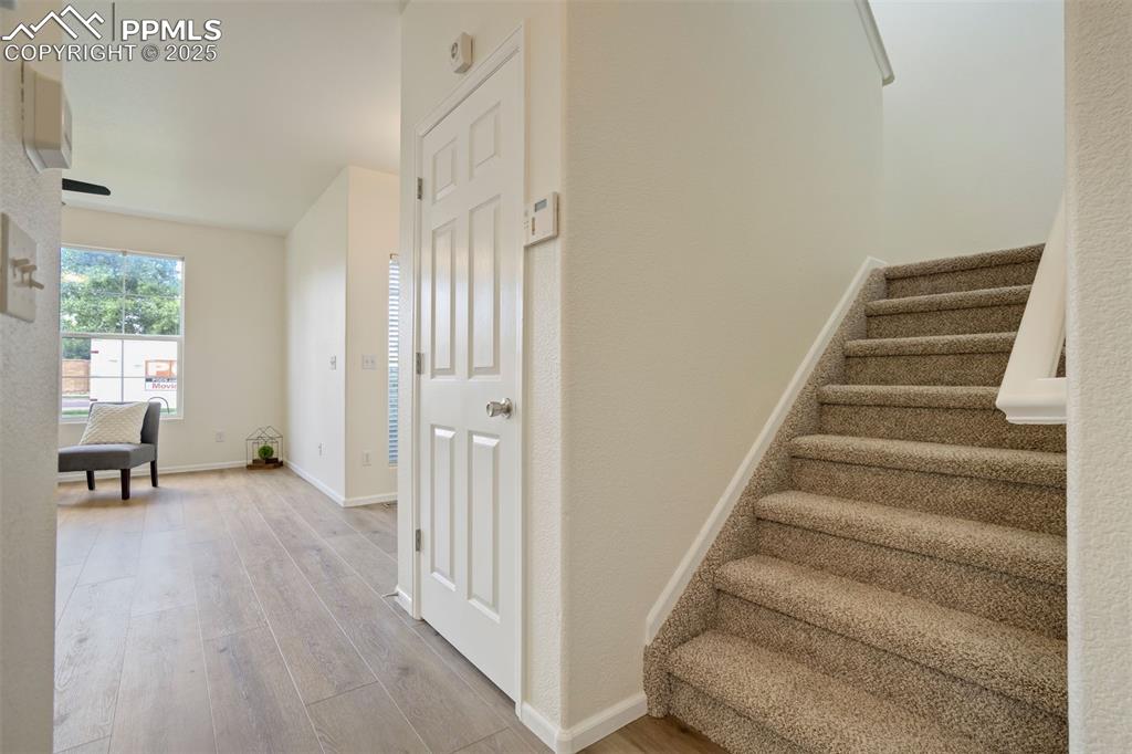 7536 Sandy Springs Point Fountain, CO 80817 - Photo 11 of 38 a view of entryway with wooden floor and stairs