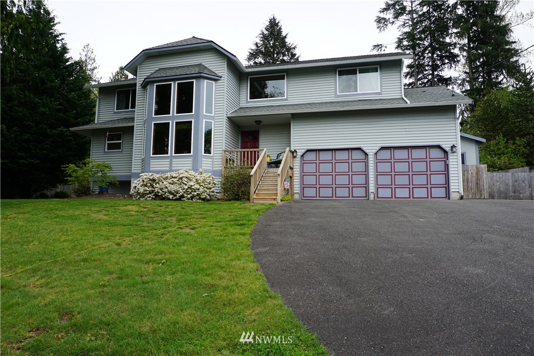 17813 Butler Road Snohomish, WA 98290 - Photo 1 of 23 a front view of a house with garden