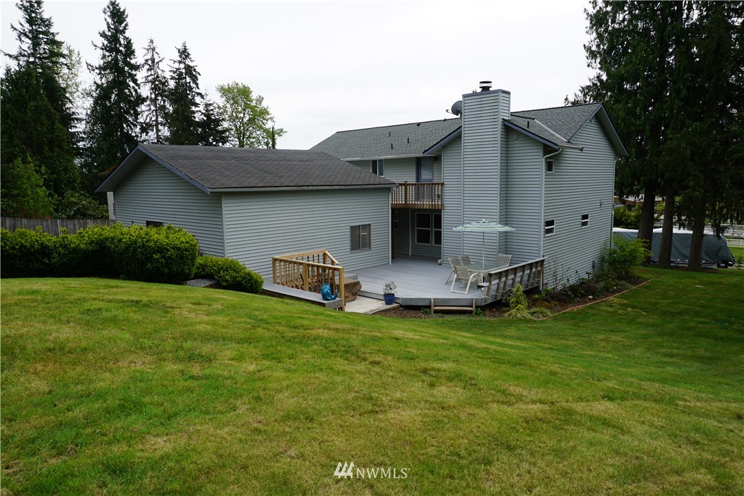 17813 Butler Road Snohomish, WA 98290 - Photo 2 of 23 a backyard of a house with table and chairs