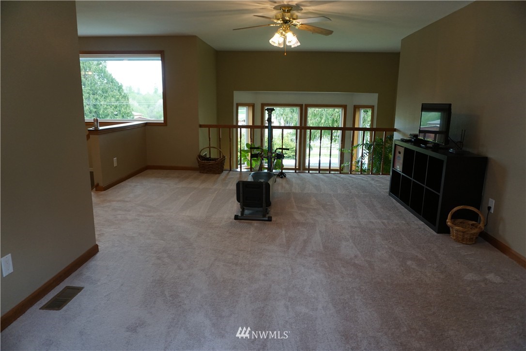 17813 Butler Road Snohomish, WA 98290 - Photo 11 of 23 a room with furniture and a flat screen tv