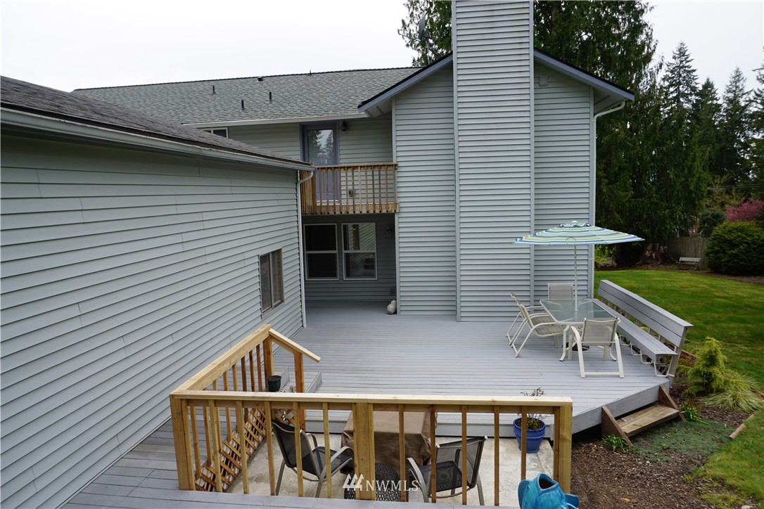 17813 Butler Road Snohomish, WA 98290 - Photo 16 of 23 a view of a house with a deck and furniture