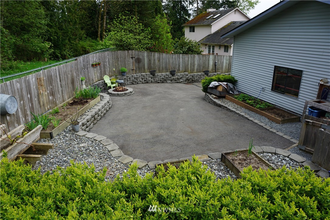 17813 Butler Road Snohomish, WA 98290 - Photo 17 of 23 a backyard of a house with chairs plants and tree