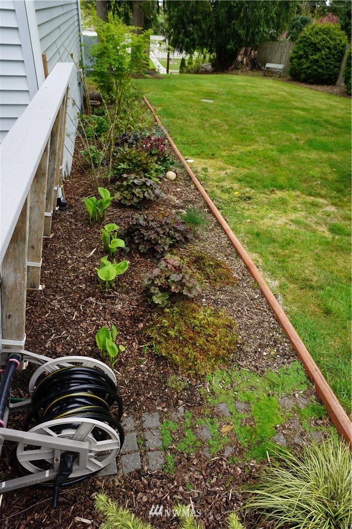 17813 Butler Road Snohomish, WA 98290 - Photo 19 of 23 a view of a garden with a bench